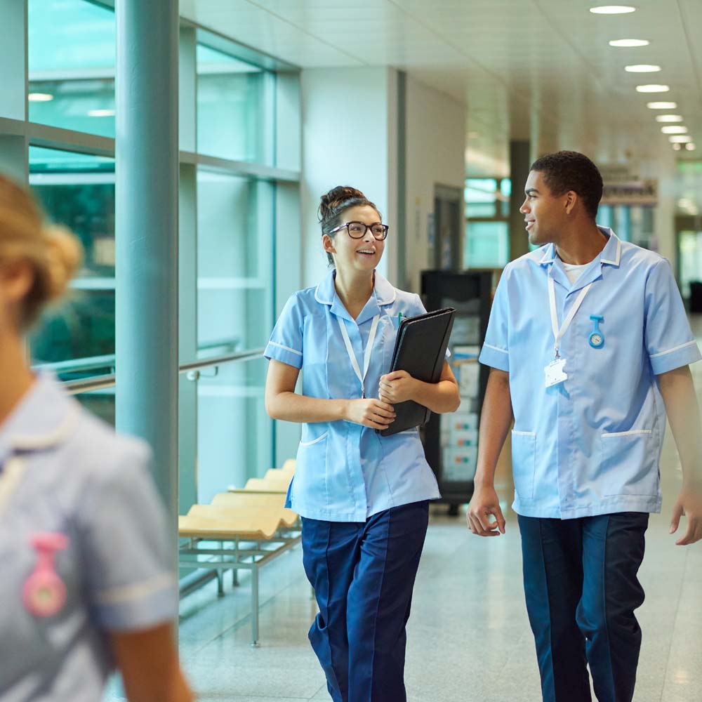 Clinicians walking down corridor in hospital