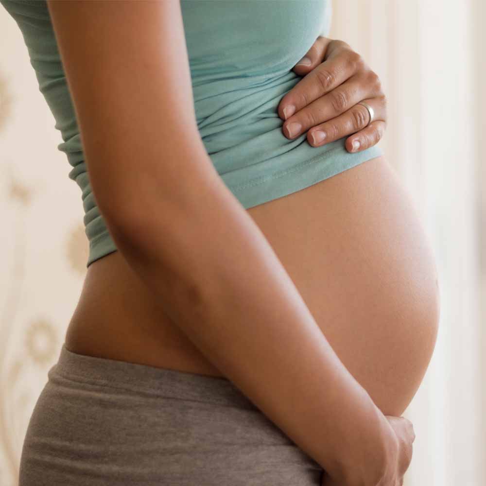 Woman holding pregnant tummy