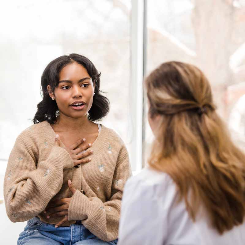 Patient describing symptoms to a clinician