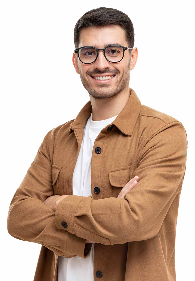 Young man smiling with arms folded